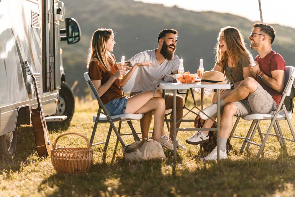 Group of friends with camping table